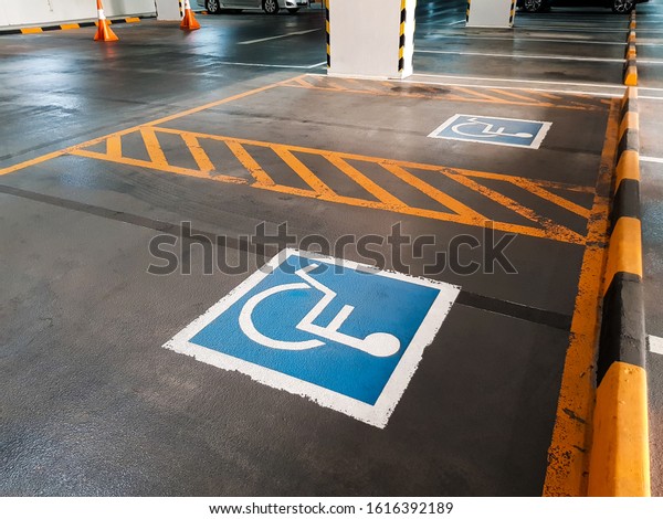 Disable
sign in the parking lot. Reserve parking area restriction for
disability, handicap or people who use wheel chair. Support and
care for other people. Equality society
concept.