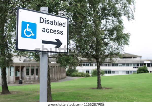 Disabled access sign for wheelchair users\
directional arrow at\
school