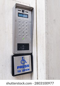 Disabled accessible push button buzzer for assistance sign at building entrance 