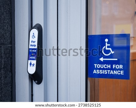 Disabled accessible push button buzzer for assistance sign at building entrance 