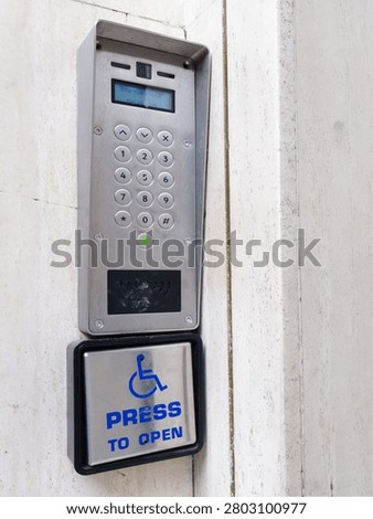 Disabled accessible push button buzzer for assistance sign at building entrance 