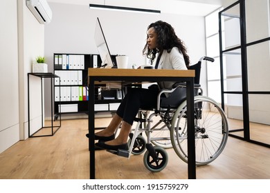 Disabled African Worker In Wheelchair Working On Computer