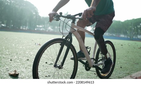 A disabled amputee cyclist riding bicycle with prosthetic leg - Powered by Shutterstock