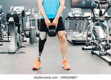 Disabled Athlete With Leg Prosthesis Training At The Gym. Paralympic Sport Concept.