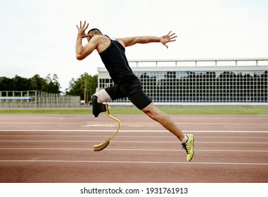 disabled athlete runner on prosthetic leg on track of stadium - Powered by Shutterstock