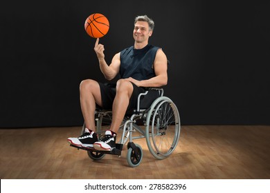 Disabled Basketball Player On Wheelchair Spinning Ball On His Finger - Powered by Shutterstock