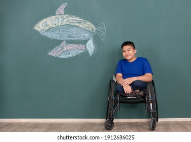 Disabled boy on wheelchair showing his painting on wall with happy and proud. Idea for learning ability of handicapped kid