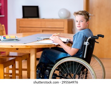 disabled boy in wheelchair doing homework - Powered by Shutterstock