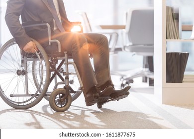 Disabled Businessman On Wheel Chair In Office 