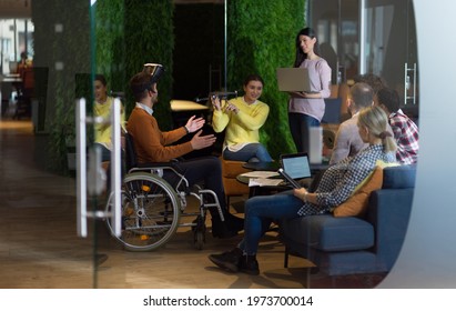 Disabled businessman in a wheelchair at work in modern open space coworking office with team using virtual reality googles drone assistance simulation - Powered by Shutterstock