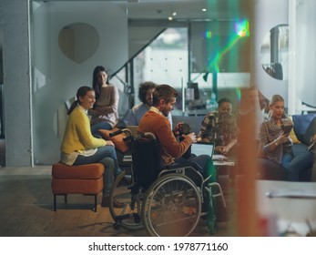 Disabled businessman in a wheelchair at work in modern open space coworking office with team using virtual reality googles drone assistance simulation - Powered by Shutterstock