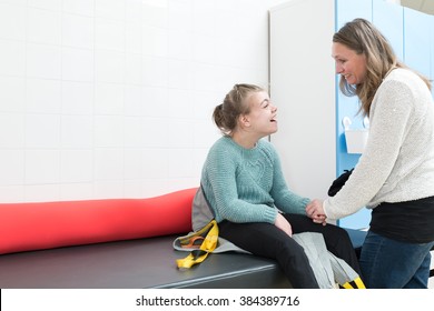 Disabled Child Being Cared For By A Special Needs Carer / Working With Disability