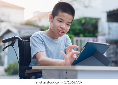 Disabled Child On Wheelchair Happy Time To Use A Tablet In The House, Study And Work At Home For Safety From Covid 19, Life In The Education Age Of Special Need Kid, Happy Disability Boy Concept.