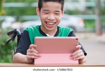 Disabled Child On Wheelchair Happy Time To Use A Tablet In The House, Study And Work At Home For Safety From Covid 19, Life In The Education Age Of Special Need Kid, Happy Disability Boy Concept.