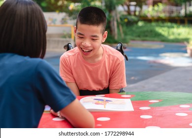 Disabled Child On Wheelchair Happy Time To Home School And Reading A Book, Study And Work At Home For Safety From Covid 19, Life In The Education Age Of Special Need Kid, Happy Disability Boy Concept.