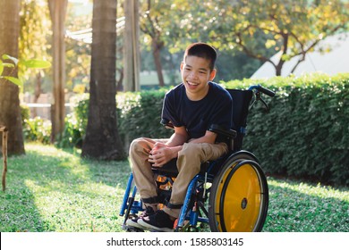 Disabled Child On Wheelchair Is Playing, Learning And Exercise In The Outdoor City Park Like Other People,Lifestyle Of Special Child,Life In The Education Age Of Children,Happy Disability Kid Concept.