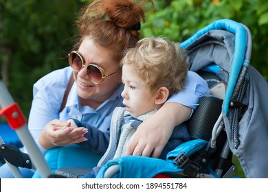 Disabled Child On Wheelchair Is Playing, Learning And Exercise In The Outdoor City Park Like Other People With Family,Lifestyle Of Special Child,Life In The Education Age,Happy Disability Kid Concept.