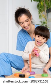 Disabled Child Is Playing, Learning And Exercising In Rehabilitation Therapy Hospital, Lifestyle Of A Child With Disability. Happy Disability Kid Concept .