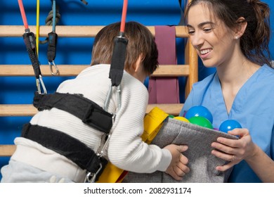 Disabled Child Is Playing, Learning And Exercising In Rehabilitation Therapy Hospital, Lifestyle Of A Child With Disability. Happy Disability Kid Concept .