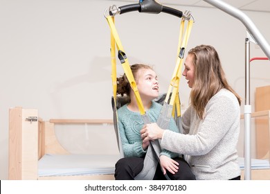 Disabled Child Together With A Special Needs Carer / Working With Disability