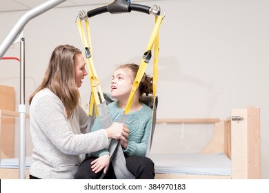 Disabled Child Together With A Special Needs Carer / Working With Disability