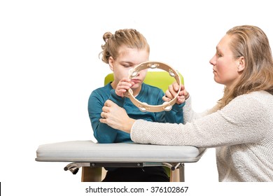 A Disabled Child In A Wheelchair Having Music Therapy Together With A Special Needs Carer