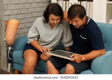 A disabled couple is choosing solar panels to install at their home. - Powered by Shutterstock