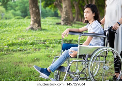 Disabled Daughter In Wheelchair Feeling Sad,asian Little Child Girl With Depressive Symptoms,left Leg Amputee,crippled,depression,caregiver Or Mother Care,support In Outdoor Park,disability Concept