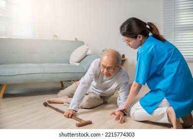 Disabled Elderly Man Patient With Walking Stick Fall On Ground And Caring Assistant At Nursing House, Asian Senior Old Man Falling Down On Lying Floor And Woman Nurse Helping Support In Living Room