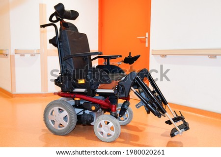 disabled electric chair empty in corridor hospital wheelchair indoors