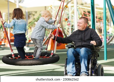 Disabled Father play with his little son and daughter