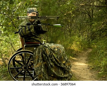 disabled hunter in wheelchair using a crossbow - Powered by Shutterstock