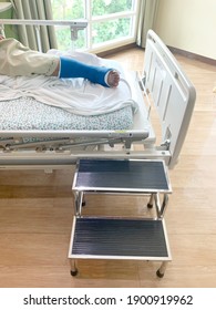 Disabled Injured Person With Sprained or Broken Ankle or Foot. patient be in plaster cast or splint in hospital lying on patient bed or stretcher and foot stool