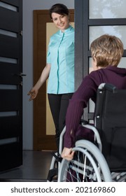 Disabled Lady On A Wheelchair Coming Back Home