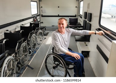 disabled man in ambulift drives to an airplane at the airport, handicapped rehabilitation 