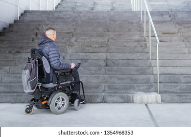 Disabled man on an electric wheelchair who can't get up the stairs