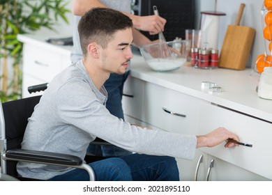 disabled man on wheelchair look into a shelf