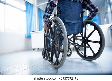 A disabled man on a wheelchair in the office Young man with disabilities in Asia. A man on a wheelchair Recovery and health care ideas Teamwork in Office - Powered by Shutterstock