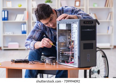 Disabled Man On Wheelchair Repairing Computer