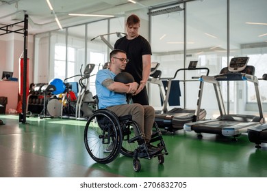 Disabled man practice controlled exercised with medicine ball, rotational and one sided lifts under supervision. Therapeutic workout, inclusive upper body sports, trainer support rehabilitation