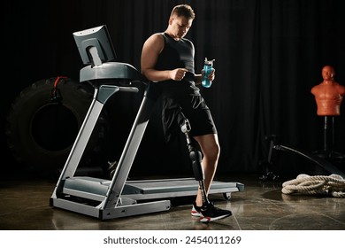 A disabled man with a prosthetic leg stands on a treadmill, holding a water bottle while working out in a gym. - Powered by Shutterstock