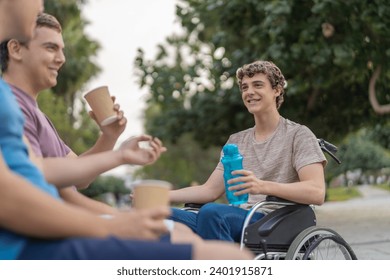 Disabled man in wheelchair and friends drinking coffee in a park - Powered by Shutterstock