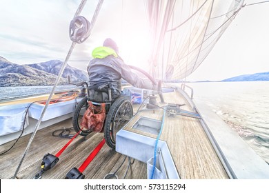 Disabled Man With Wheelchair On Sailing Boat 