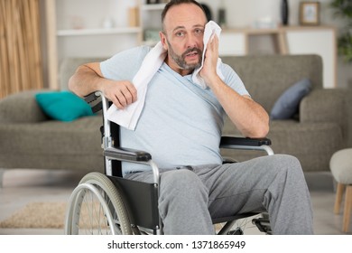 Disabled Man Wiping Sweat From His Brow After Exercising