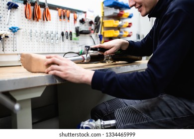 Disabled man working in amputee shop for production prosthetic extremity parts. - Shutterstock ID 1334465999