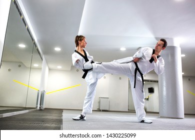 Disabled Martial Art Athlete Performing A Combat Simulation In Taekwondo With Her Coach