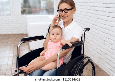 Disabled Mother In Wheelchair Work With Newborn. Disabled, Motherhood Concept.