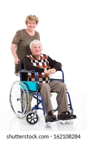 Disabled Old Man Sitting On Wheelchair With Caring Wife On White Background