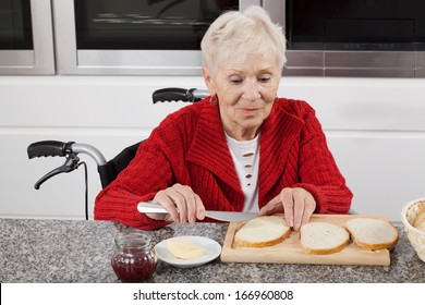 Disabled older woman preparing sandwiches for breakfast