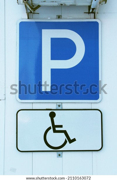 Disabled parking permit sign on white\
background. Parking sign for people with\
disabilities